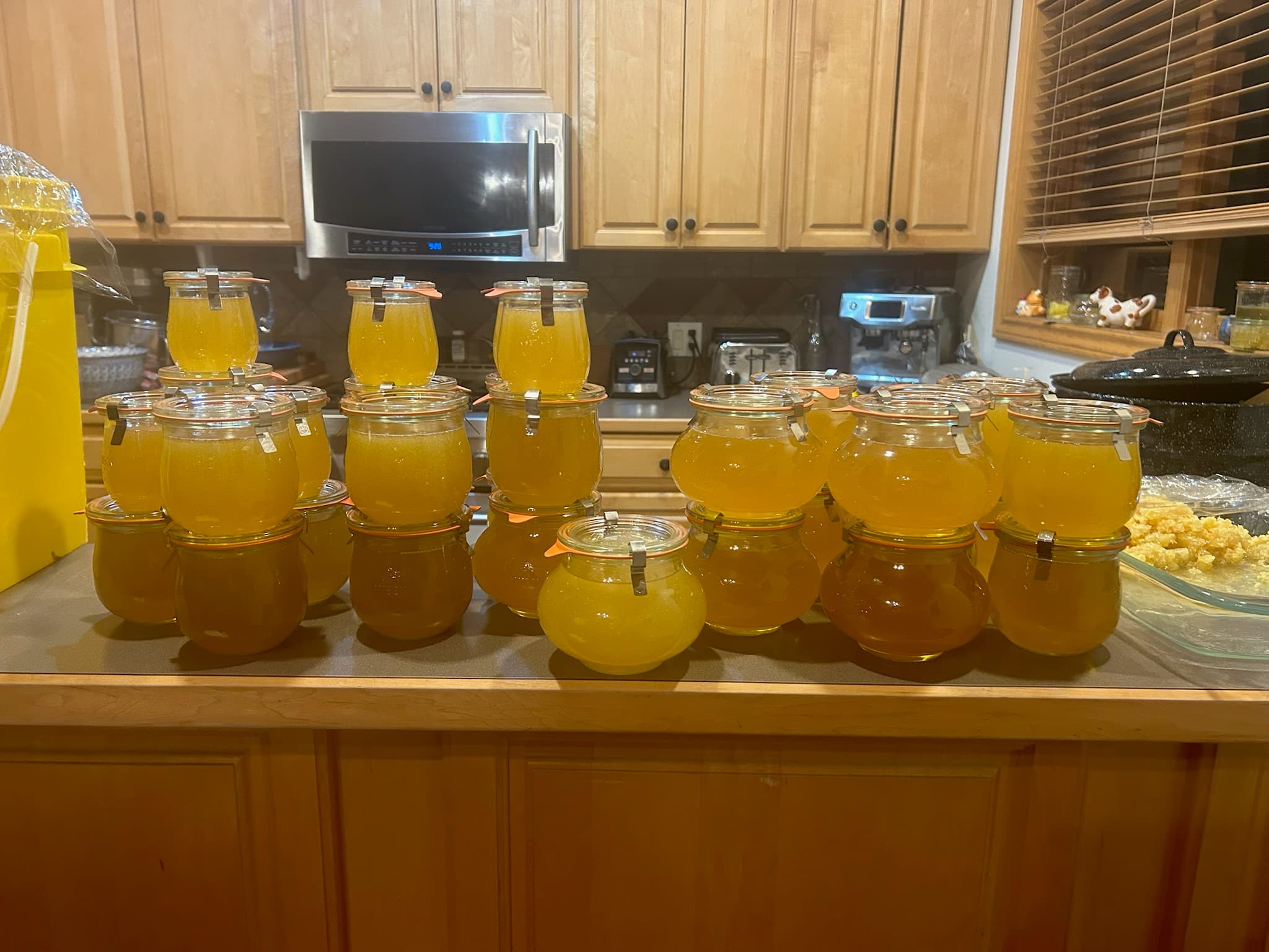 Freshly filled honey jars lined across a kitchen counter